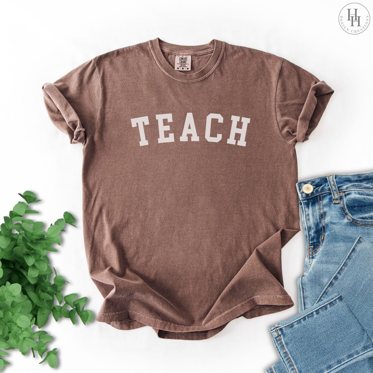 Espresso brown t-shirt with 'TEACH' text on a white background.